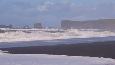 Reynisfjara Beach with subtle rainbow waves and mist at Dyrholaey Video stock 329443084