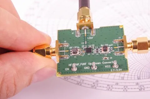 RF engineer inspect microwave mixer PCB Stock Photos