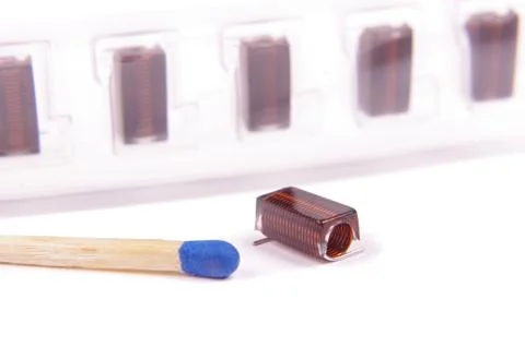 RF inductor for electronics in comparison with match head Stock Photos