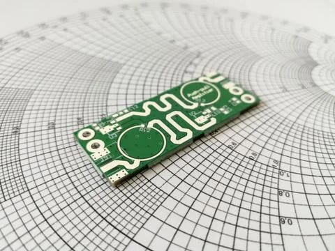 RF PCB in front of Smith chart Stock Photos
