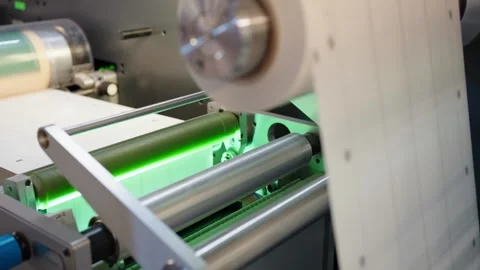 RFID label web runs through rollers on an automated roll-to-roll converting Vídeos de archivo 348127818