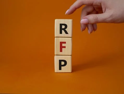 RFP - Request for Proposal. Wooden cubes with word RFP. Businessman hand. B.. Stock Photos