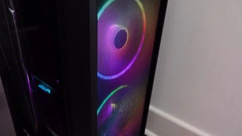 RGB fans light up a computer case in a room Stock Footage 328996261