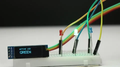RGB LEDs glowing in sequence while an OLED display shows the active color Stock Footage 336626546