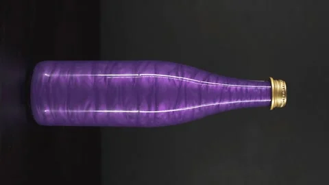 Rheoscopic liquid inside glass bottle on black background.Violet. Vertical video 스톡 동영상 252032707