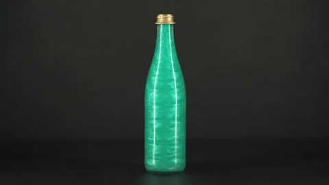 Rheoscopic liquid inside glass bottle on black background. Green. Stock Footage 252033148
