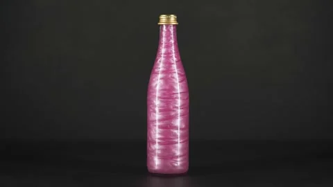 Rheoscopic liquid inside glass bottle on black background. Pink. Stock Footage 252033376