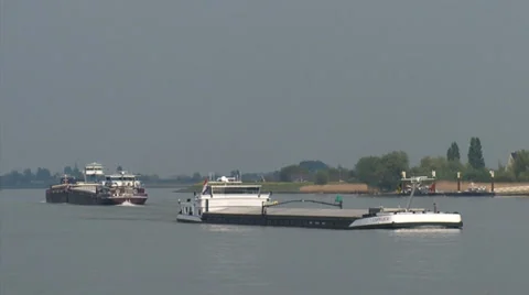 Rhine barges and container ship navigate Lek river + zoom out skyline Lekkerkerk Stock Footage 38504582