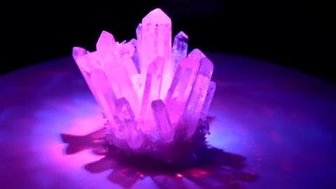 Rhinestone crystal rotates around in colored laser beams. Large crystals of n Stock Footage 152647645