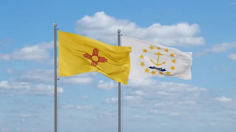 Rhode Island and New Mexico US state flags waving together 스톡 동영상 260047039