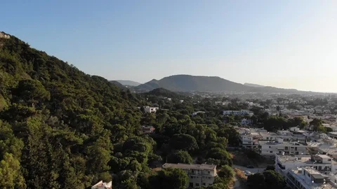 Rhodes mountain spiral down pan green trees Stock Footage