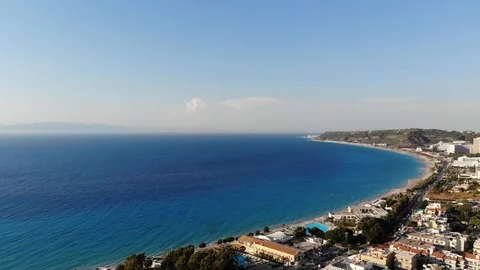 Rhodos island with Turkey across the blue sea panning Drone sun Stock Footage