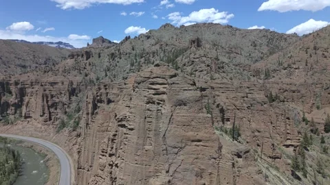 Rhyolite Cliffs and Winding Highway in Shoshone Canyon Wyoming Orbit Stock Footage 336745937