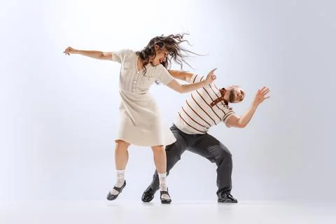Rhythm and expression. Energetic dance couple in retro style outfits dancing Fotos Stock