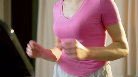 Rhythmic jogging of unrecognizable female torso on treadmill during home cardio 스톡 동영상 333777450