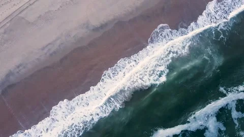 The rhythmic lines of ocean waves rolling to the shore, Natural Pattern Stock-Footage 316820645