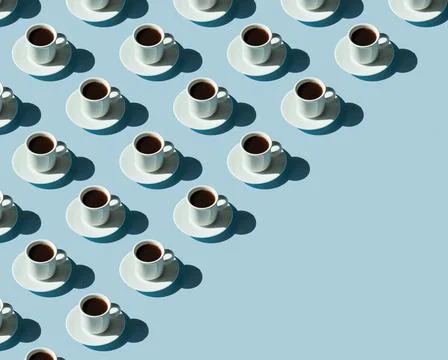 Rhythmic pattern from cups with coffee on a blue background. Stock Photos