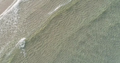 Rhythmic waves washing onto a sandy beach from above The Concept of peace a.. 库存影片 334731878