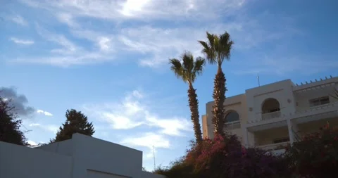 Riad holiday house  with palm trees at dusk, 4K Stock Footage 235356830