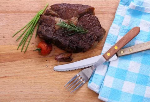 Rib eye steak, cherry tomatoes, garlic, herbs Stock Photos