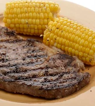 Rib eye steak with corn Stock Photos