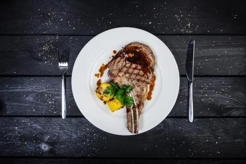 Rib-eye steak with corn. Stock Photos