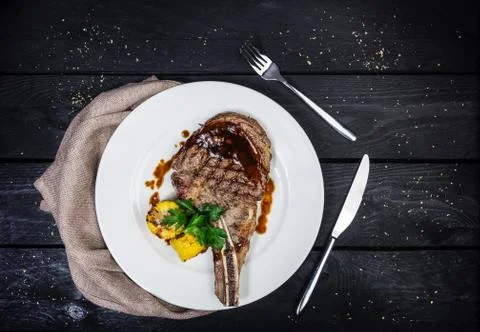Rib-eye steak with corn. Stock Photos