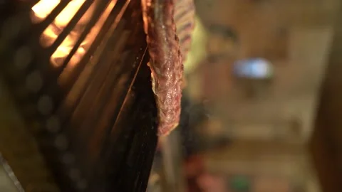 Rib meat is oiled and cooked on the grill 4K 100fps Vertical Stock Footage 181111144