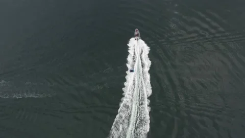 Rib rides, with doughnut attached behind, top down drone Stock Footage 143037624