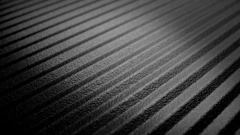 Ribbed metal surface with diagonal patterns, glossy highlights, and shadows Stock Footage 345024750