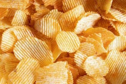 Ribbed potato chips close-up as background Stock Photos