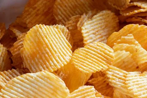 Ribbed potato chips close-up as background Stock Photos