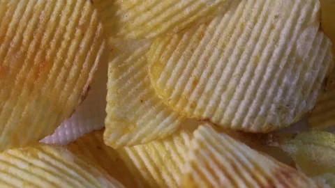 Ribbed potato chips spin slowly. fast food background Stock Footage 306073770