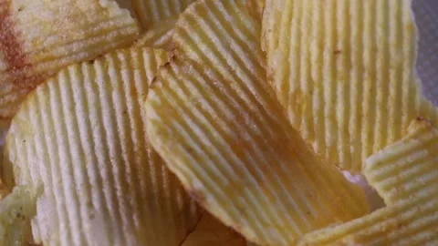 Ribbed potato chips spin slowly. fast food background Video stock 306073802
