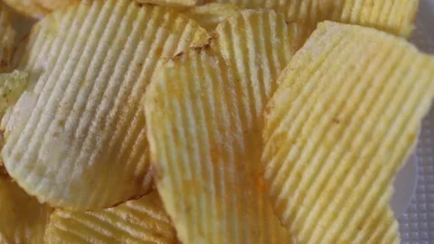 Ribbed potato chips spin slowly. fast food background Stock Footage 306073834