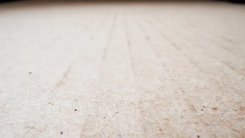 Ribbed surface of beige cardboard sheet at bright light Video stock 179547752