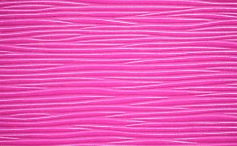 A ribbed surface with a wavy pattern of natural wood, rounded in a bright pur Stock Photos