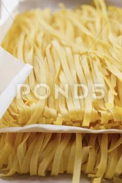 Ribbon pasta on paper Stock Photos