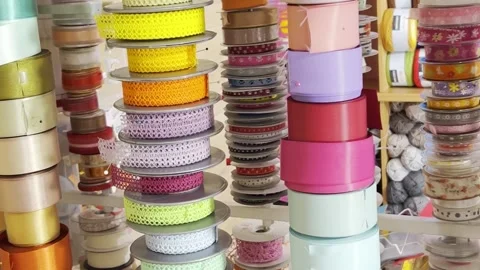 Ribbons of different colors from different materials. Textile shop. Vertical Stock-Footage 250112342