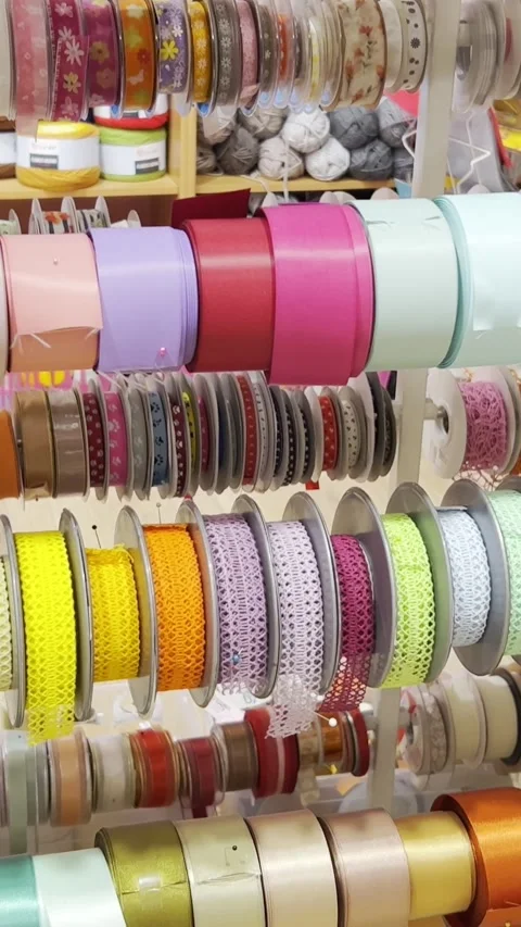 Ribbons of different colors from different materials. Textile shop. Vertical Stock Footage 250385593
