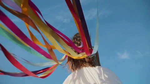 Ribbons flutter in the wind in girl hands Stock Footage 132483687