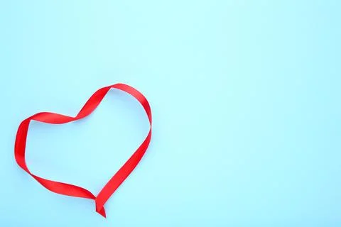 Ribbons shaped as hearts on blue, valentines day concept Stock Photos
