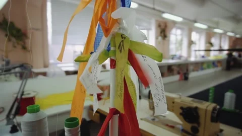 Ribbons with working tasks tied on pillar in sewing workshop Stock Footage 236908252