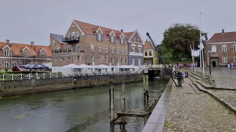 Ribe Canal Harbor with Large Brick Building and Pedestrian Bridge, Denmark Stock Footage 333896800