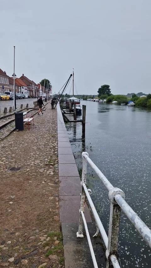 Ribe Harbor Waterfront Walk with River View and Moored Vessel, Ribe, Denmark Stock Footage 333896671