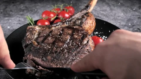 Ribeye Tomahawk Steak, Irish Beef, grilled ,cuts with a knife Stock Footage 194485269