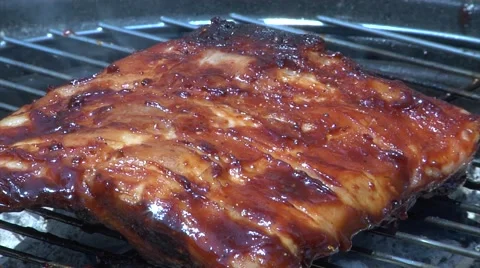 Ribs being basted on the bbq barbecue Stock Footage