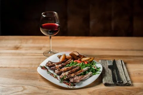Ribs, cooked grill, with vegetables lie in plate. Stock-Fotos