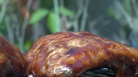 Ribs cooking on the bbq barbecue while being basted 動画素材 46122658