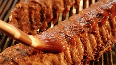 Ribs on Grill being brushed with Barbeque Sauce GT9035 Stock Footage 129639490